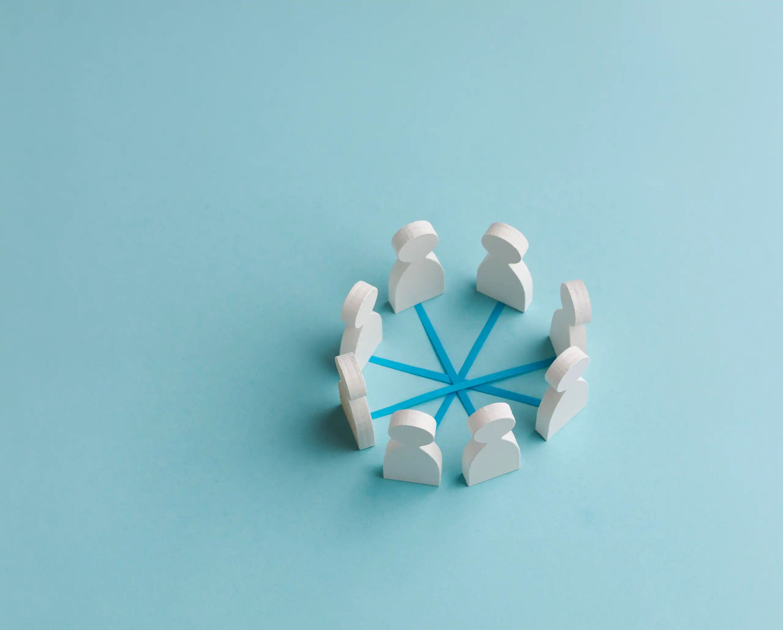 Wooden figure next to blocks showing employment, skills and training icons