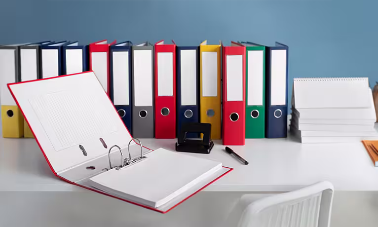 Open binder with folders and documents, representing annual reports and accountability