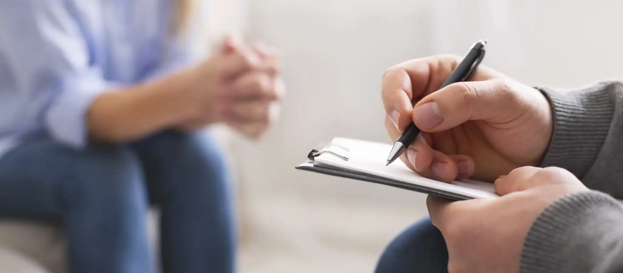 Counsellor taking notes during a counselling session